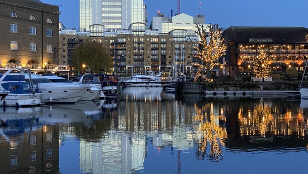 A waterfront hotel with a view of the city skyline, including a prominent building with a glass facade. - Modern London Tower Bridge apartment (London)
