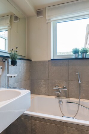 Een bad, een haardroger, handdoeken, zeep