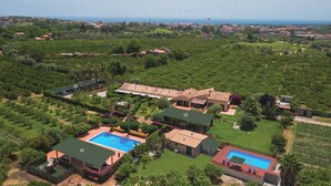An aerial view of a residential area with numbered buildings, a swimming pool, and surrounding greenery.