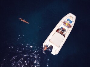 A boat with a covered deck and a motor at the stern.