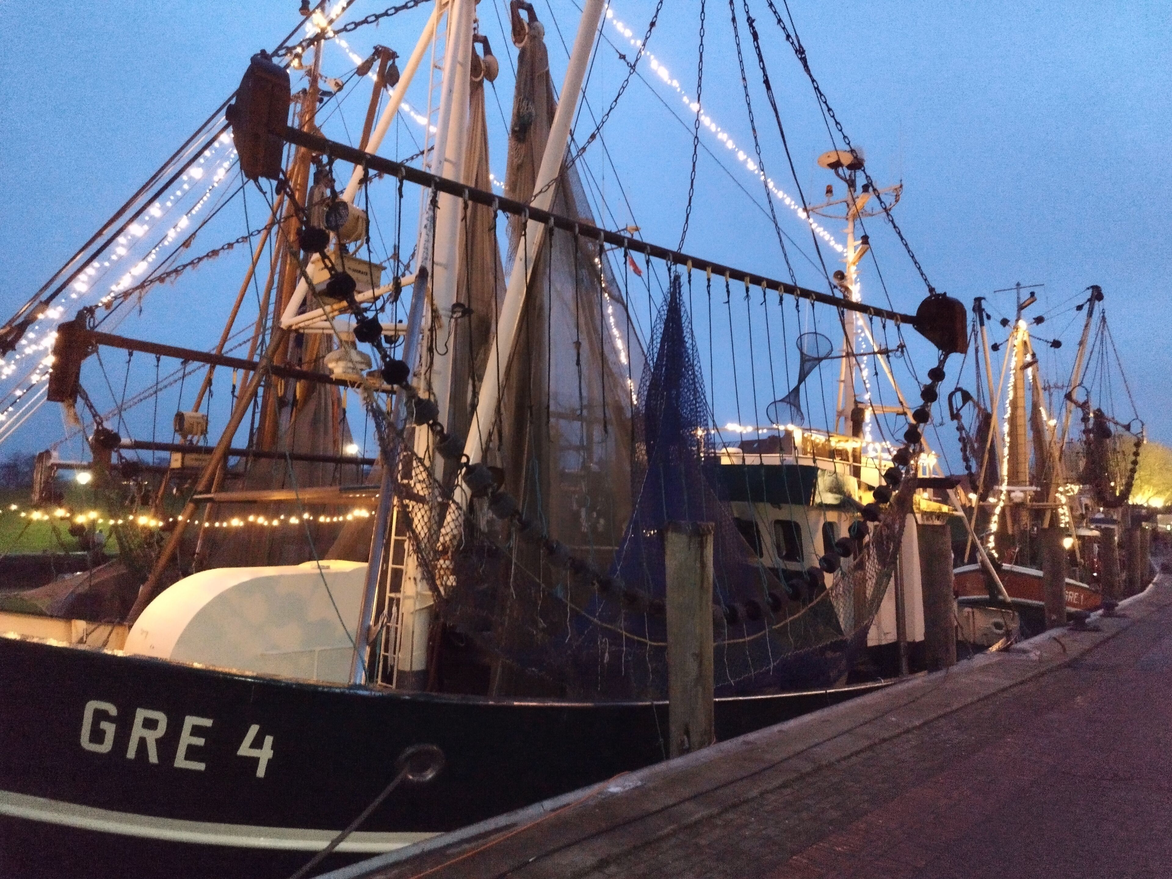 A docked ship with the name 'GRE 4' visible on its side.