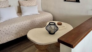 A room with a sofa, a round table, and a wall-mounted picture frame. - Le Nid des Baronnies: Rated 3-star vacation key! (Mirabel-Aux-Baronnies)