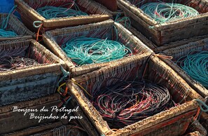 A collection of wooden crates filled with colorful fishing nets.
