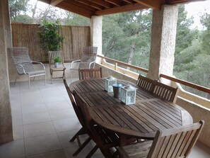Enjoy dining al fresco with a view of the surrounding woods from this outdoor patio.