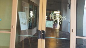 A building entrance with the sign "Herons Nest" above the doors. - Beautiful 3 Bedroom 2 Bath Home in a Resort-like Community.   (North Fort Myers)