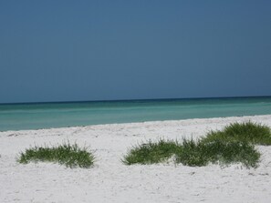 Una playa con arena blanca y agua turquesa cristalina.