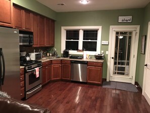 Enjoy cooking in this well-equipped kitchen with a refrigerator, microwave, oven, and dishwasher.