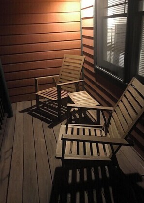 Guests can enjoy an outdoor space with three chairs.