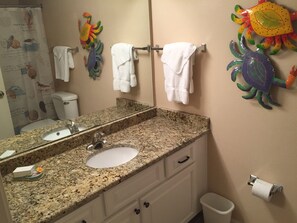 Combined shower/bathtub, towels, toilet paper