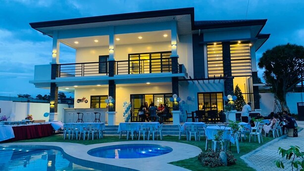 A modern two-story building with a pool, outdoor seating, and a Christmas tree. - Beautiful "Casa Grande" Luxury Villa in Davao City (Davao)