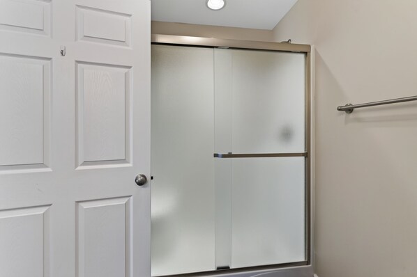 A white door with a frosted glass panel and a metal handle.