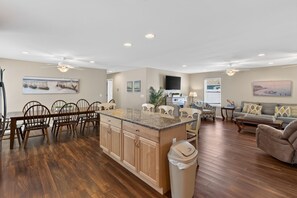 A spacious living area with a kitchen island, dining table, and seating arrangements. - Rehoboth Beach Private Pool Fire Pit One Level (Rehoboth Beach)