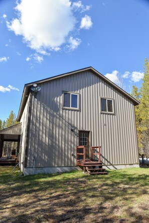 A single-story building with a front porch, a door, and a small window.
