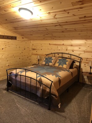 Cozy bedroom with a single bed, bedside table, and lamp.