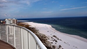 A beach view from a balcony with a railing, ocean, and buildings in the background. - YaaHooo!!!!! Blue Velvet / Turquoise Place / FABULOUS !!!!!!!!! (Orange Beach)