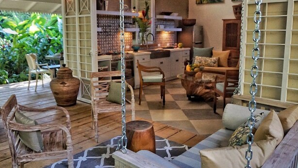 A cozy outdoor seating area with wooden furniture, a swing, and a checkered floor. - 4BR Boutique Jungle Villa • Private Pool • Walkable Manuel Antonio (Manuel Antonio)