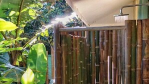 A bamboo water feature with a small pool, surrounded by lush greenery. - 4BR Boutique Jungle Villa • Private Pool • Walkable Manuel Antonio (Manuel Antonio)