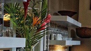 A modern kitchen with a black sink, wooden countertop, and a vase with flowers. - 4BR Boutique Jungle Villa • Private Pool • Walkable Manuel Antonio (Manuel Antonio)