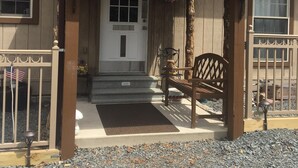 A house with a porch, a front door, and a small front yard. - 4 Bedroom House - Great Views - Secluded Location (Jim Thorpe)