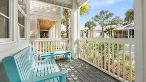 A covered porch with a wooden bench and a table, surrounded by a white fence and palm trees. - Sunsets Look Better From Above at The Upper Deck / Lagoon Pool in Seacrest Beach / 4 Bikes (Rosemary Bch)
