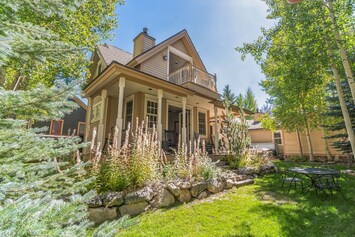 Backyard with hot tub, wrap-around covered patio, and fire pit