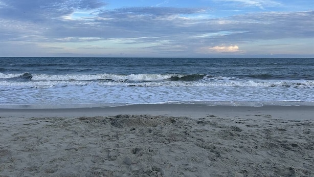 A beach with waves and a clear sky. - Clean Beach House on 2nd row easy access to beach! (Cherry Grove)
