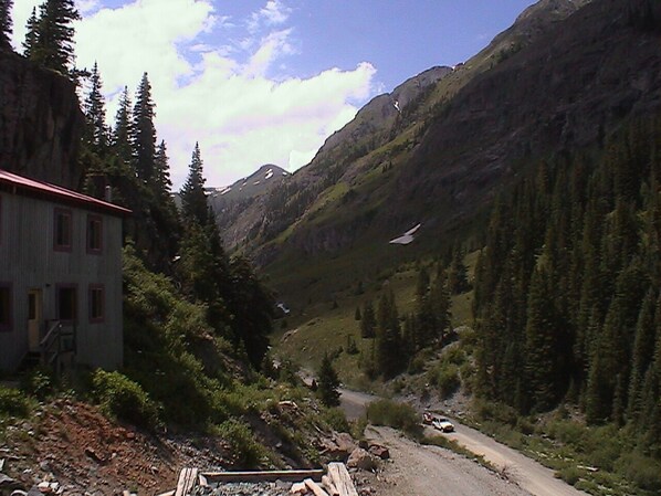 A mountain landscape with a building on the left.