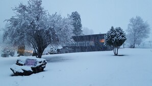 A snow-covered landscape with a building, trees, and a sign in the foreground. - Welcome to Lenore Lodge, located along the wild & scenic Clearwater River. (Lenore)
