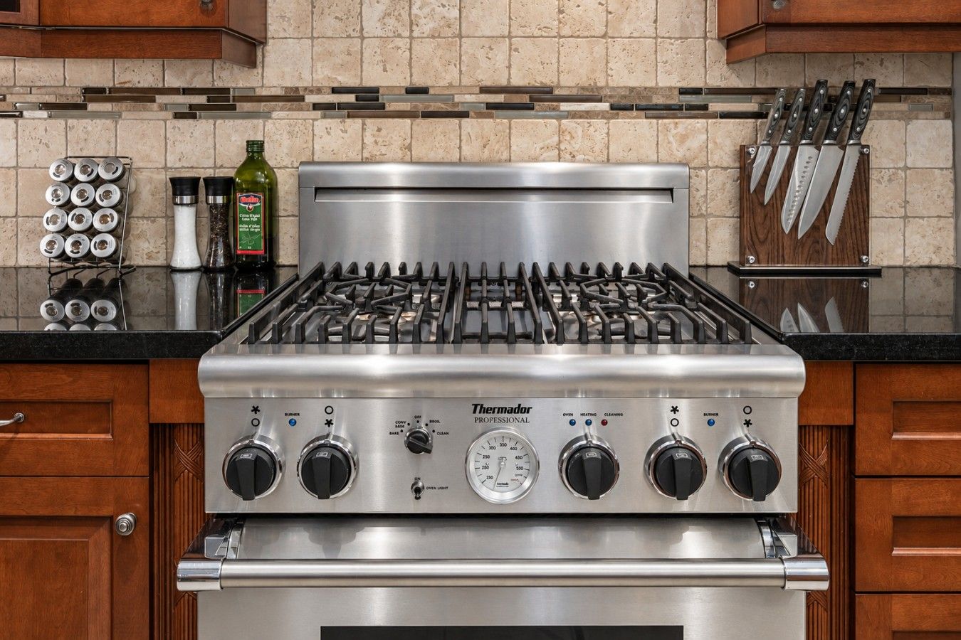 A stainless steel Thermador Professional gas range with four burners, a control panel, and a built-in oven.