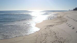 A beach with a clear sky and the sun shining. - Sunny paradise! Beachfront, bay views & all the amenities! Welcome families! (Orange Beach)