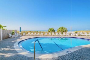A swimming pool with lounge chairs and a view of the beach. - **BEACH FRONT CONDO**  OUTSTANDING LOCATION!! AND A BREATH-TAKING VIEW** (Madeira Beach)