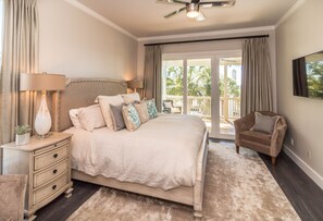 A bedroom with a bed, bedside tables, a chair, and a balcony with curtains. - Inlet Beach, Private Heated Pool, Beachfront, Daily Beach Chair Service (Inlet Beach)