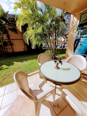 Relax in a serene outdoor space surrounded by lush greenery and tropical plants.