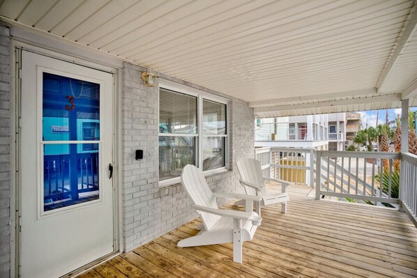 Relax on the covered porch with two Adirondack chairs and enjoy the view from the balcony.