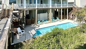A two-story house with a balcony and a swimming pool. - OCEAN FRONT with POOL, Great LOCATION near pier, 5 bed & 5 bath (Ocean Isle Beach)
