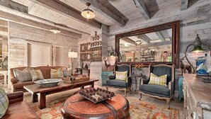 A rustic interior with a wooden ceiling, a large mirror, and a variety of seating including a sofa and armchairs. - LUXURY 4 Kng Bdrm, 4.5 Bth, Gourmet Kitchen, Pavilion; TV, Fire Place, Heaters (Asheville)