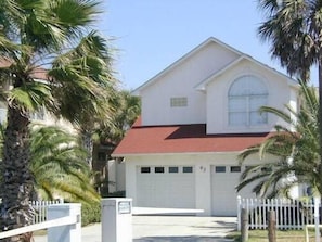 Stunning two-story home with arched window and garden.