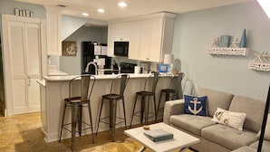 A compact living space with a kitchenette, a dining area with bar stools, and a seating area with a sofa and coffee table. - Amazing Location in Beautiful Blue Mountain Beach.  75 Yards from the Sand...   (Santa Rosa Beach)