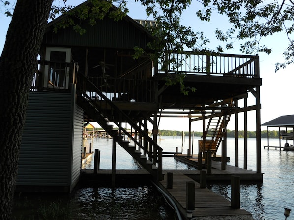 A dock extending from a building with a staircase leading to a deck area.
