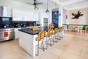 Enjoy cooking in this well-lit kitchen with a large island and oven and gas range.