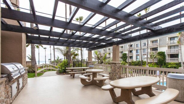 An outdoor patio with picnic tables and a barbecue grill. - Paradise found in Oceanside with panoramic ocean view (Oceanside)