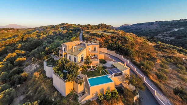 A large, modern house with a swimming pool, surrounded by a natural landscape. - Spacious villa with full privacy & nature views! (Rethymno)