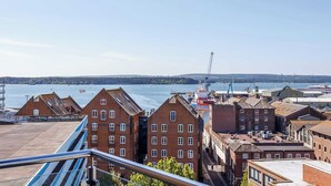 A waterfront view with brick buildings, a crane, and a large ship docked. - Purbecks  - Superb views to Poole Harbour and Purbeck Hills (Poole)