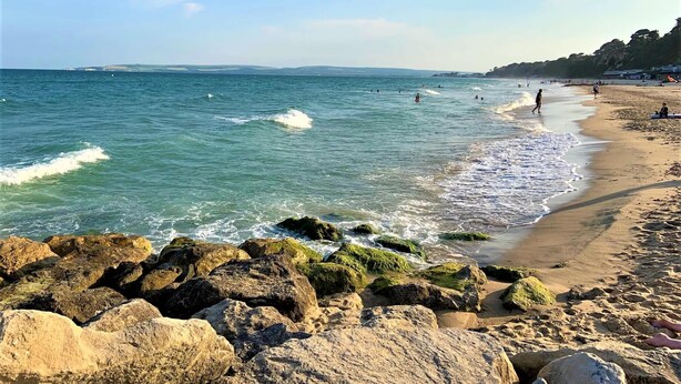 A beach with rocky foreground, clear blue water, and a sandy shore. - Purbecks  - Superb views to Poole Harbour and Purbeck Hills (Poole)