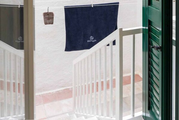 A staircase with white railings and a green door.