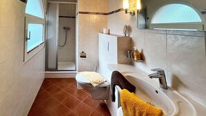 A modern bathroom with a shower, toilet, sink, and a large mirror. - Apartment 1 - House Erna (Bad Wildungen)