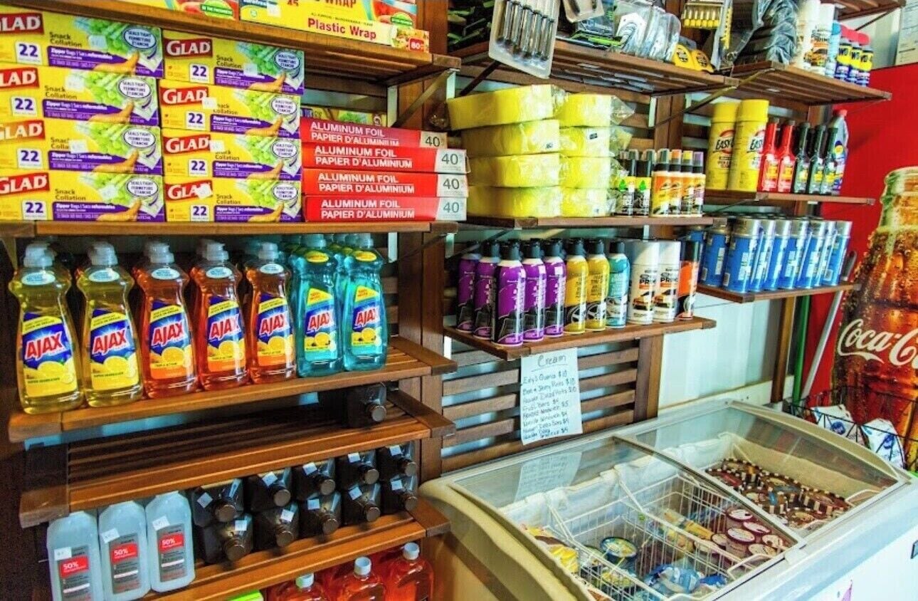 A store with shelves stocked with aluminum foil, paper towels, and cleaning products.