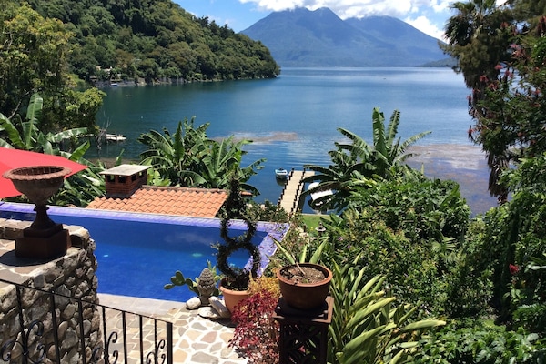 view of pool & lake from upper terrace