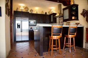 Enjoy cooking in this well-equipped kitchen with a central island and ample cabinetry.
