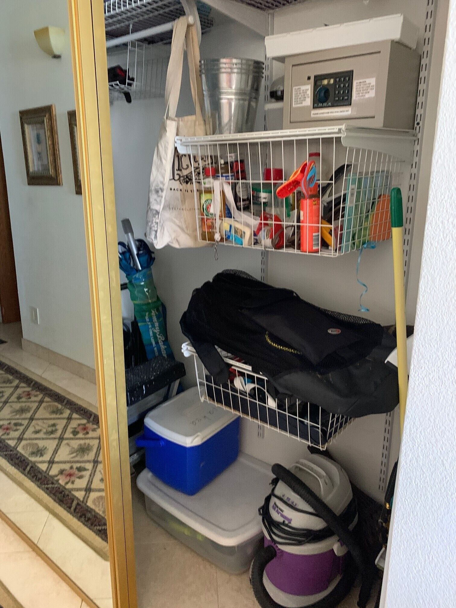 A storage area with shelves, a metal rack, and a blue container.
